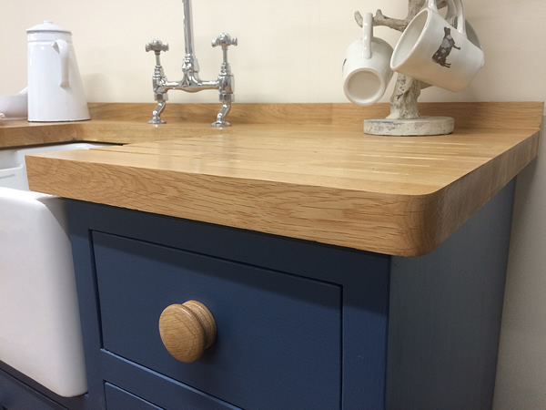 Dark blue painted freestanding Belfast sink base cupboard fitted with 55mm diameter oak knobs