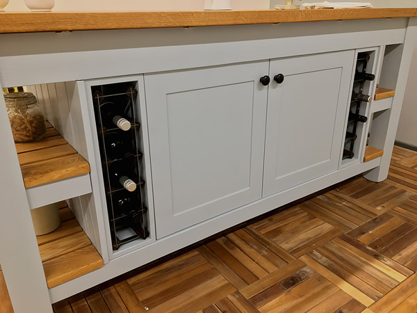 large freestanding kitchen island with double bottle storage and cupboard space