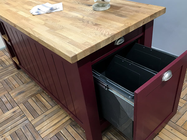 large freestanding kitchen island fitted with double pull-out waste bin