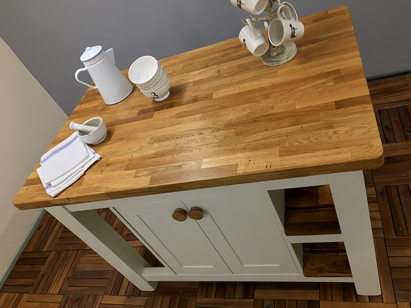 medium freestanding kitchen island fitted with an oiled rustic oak staved worktop